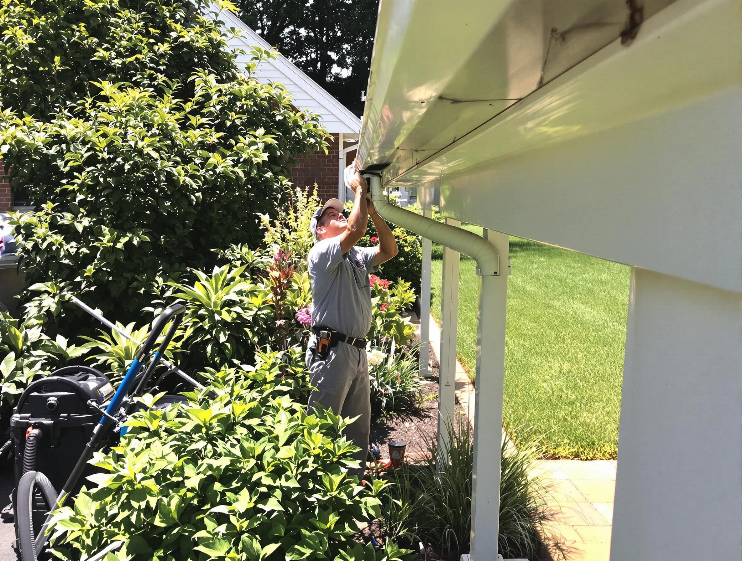 Technician flushing a blockage from a downspout in Broadview Heights, OH